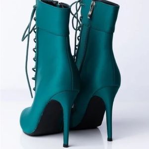 Teal lace up boots with zipper on the side.